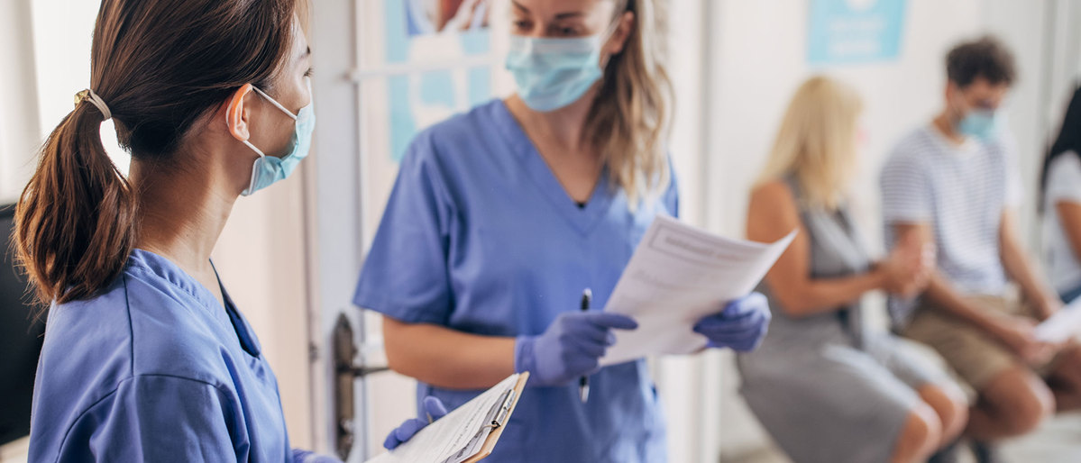 Health professionals talking with one another.